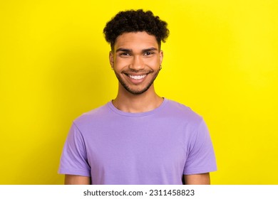 Photo of cheerful positive guy dressed purple t-shirt smiling showing white teeth isolated yellow color background - Shutterstock ID 2311458823