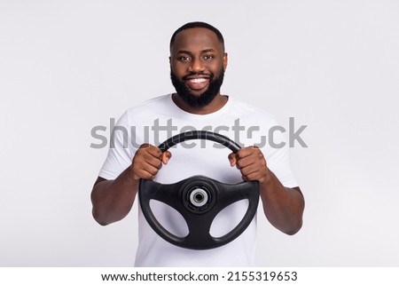 Photo of cheerful positive guy dressed casual t-shirt driving vehicle smiling isolated white color background