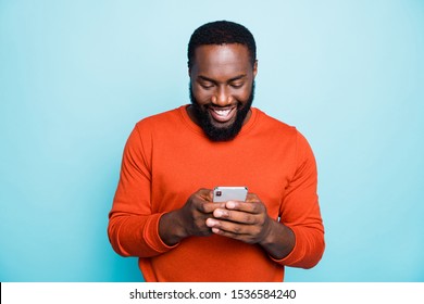 Photo of cheerful positive handsome man holding telephone smiling toothily searching information new isolated vivid blue color background