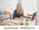 Photo of cheerful positive lady recruiter dressed shirt earphones communicating device hot line indoors workplace workstation