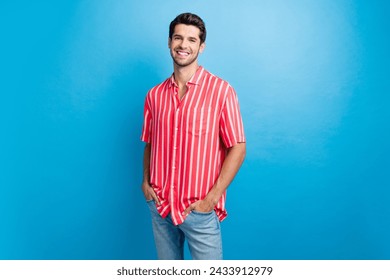 Photo of cheerful positive man dressed striped shirt smiling walking isolated blue color background - Powered by Shutterstock