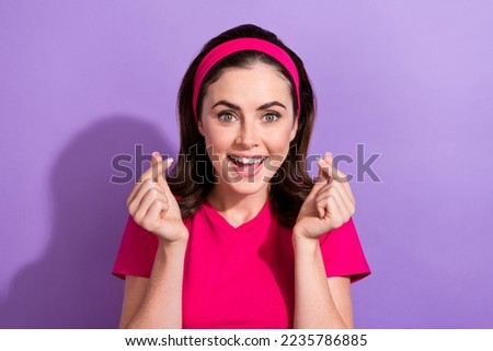 Photo of cheerful pretty lady wear bright outfit demonstrate crossed fingers korean heart love symbol isolated on purple color background