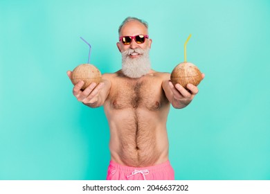 Photo of cheerful reliable old barman give you two coco cocktails wear sunglass shorts isolated teal color background - Powered by Shutterstock