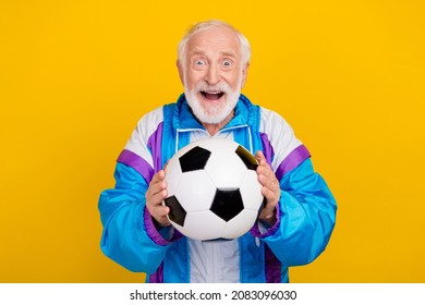 Photo Of Cheerful Retired Man Competition Football Player Intensive Isolated Over Yellow Color Background