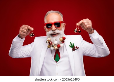 Photo of cheerful retired old positive man hold hands christmas trree balls beard smile isolated on red color background - Powered by Shutterstock