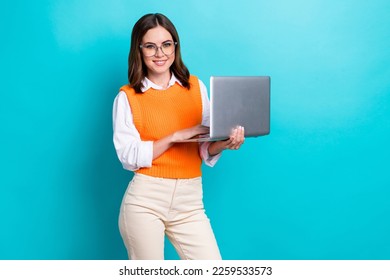 Photo of cheerful satisfied brunette hair girl wear school uniform online education teacher hold netbook isolated on aquamarine color background - Powered by Shutterstock