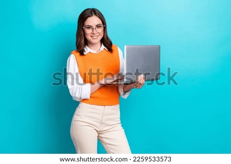Photo of cheerful satisfied brunette hair girl wear school uniform online education teacher hold netbook isolated on aquamarine color background