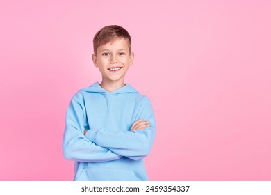 Photo of cheerful schoolkid toothy smile crossed arms posing empty space isolated on pink color background - Powered by Shutterstock