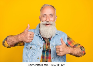 Photo of cheerful senior man show fingers thumb-up select suggest promo good isolated over yellow color background