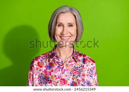 Photo of cheerful sweet lady pink shirt smiling white teeth empty space isolated green color background