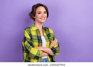 Photo of cheerful young lady wearing green plaid shirt folded arms satisfied business model good mood isolated on purple color background - Powered by Shutterstock