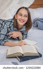 Photo Of Cheerful Young Lady Writes Down Information In Notebook With Pen, Records Plans And Notes Checklist, Makes Interesting Story, Enjoys Domestic Peaceful Atmosphere During Morning Time.