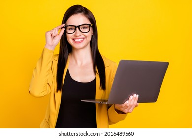 Photo Of Cheerful Young Manager Lady Hold Laptop Wear Eyewear Yellow Blazer Isolated On Vivid Color Background