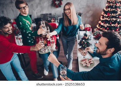 Photo of cheerful young people colleagues drink champagne circle celebrate cozy christmas party decor spacious office indoors - Powered by Shutterstock