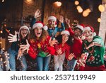 Photo of cheerful young people friends group have fun dance wave hand cheerful smile cozy christmas party decor spacious apartment indoors