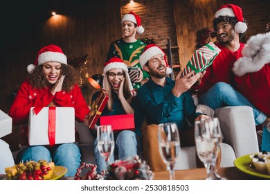 Photo of cheerful young people friends group receive gifts secret santa celebrate cozy christmas party decor spacious apartment indoors - Powered by Shutterstock