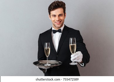 Photo Cheerful Young Waiter Standing Isolated Stock Photo 755472589 ...