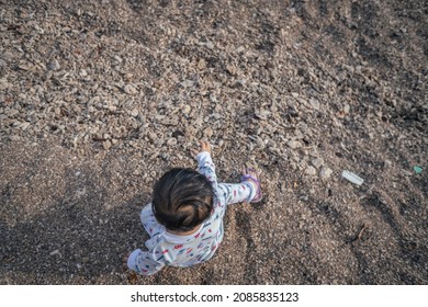 Photo Of Child Playing Sand On The Beach When Mooring Sun. The Photos Is Perfect For Poster, Pamphlet And Banner About Holiday On The Beach.