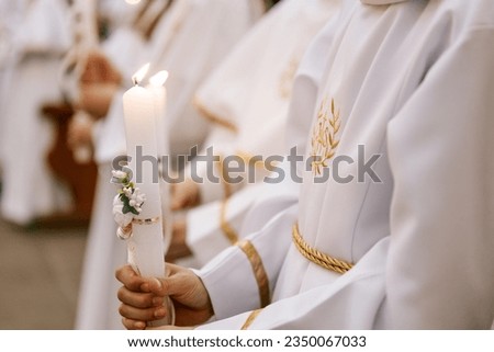 photo of children's hands receiving their first communion in a Catholic church, the priest blesses them 商業照片 © 