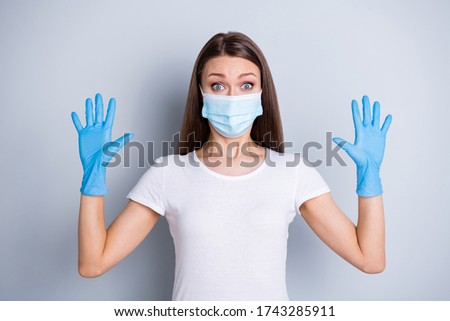 Photo of citizen funny lady keep social distance crowd people put on gloves raise arms showing max protection concept wear face mask isolated grey color background