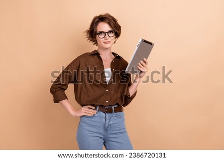 Photo of clever confident lady wear brown shirt spectacles communicating modern device isolated beige color background