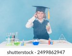 Photo of clever diligent intelligent boy learn chemistry subject doing experimental research isolated on blue color background