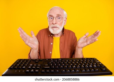 Photo Of Clueless Ignorant Grandpa Sit Computer Stupor Reaction Wear Specs Brown Shirt Isolated Yellow Color Background