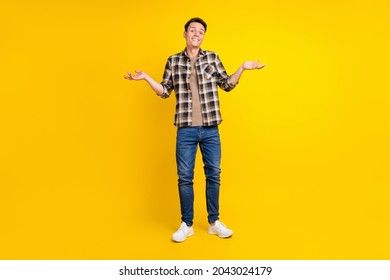 Photo Of Clueless Uncertain Guy Shrug Shoulders Wear Plaid Shirt Jeans Shoes Isolated Yellow Color Background