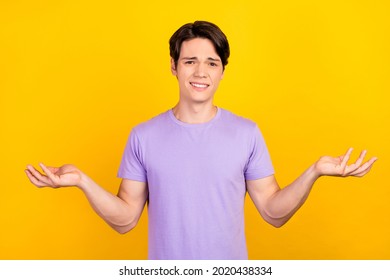 Photo Of Clueless Uncertain Loser Guy Shrug Shoulders Wear Purple T-shirt Isolated Yellow Color Background