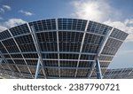 Photo collage of bilateral solar panels, photovoltaics, with natural sun flare - alternative source of electricity, concept of sustainable and renewable resources. Panoramic backwards view.