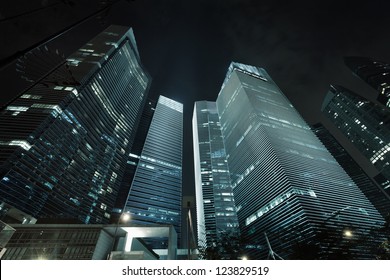 Photo Of Commercial Office Buildings Exterior. Night View At Bottom Skyscrapers.