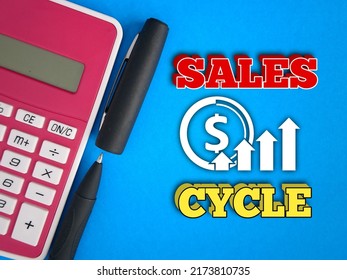 Photo Concept.Calculator, Pen, Text Sales Cycle And Icon On Blue Background. 