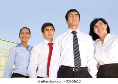 Photo Of Confident Business Team Forwards With Blue Sky Above