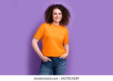 Photo of confident cheerful lady dressed orange t-shirt smiling walking empty space isolated violet color background - Powered by Shutterstock