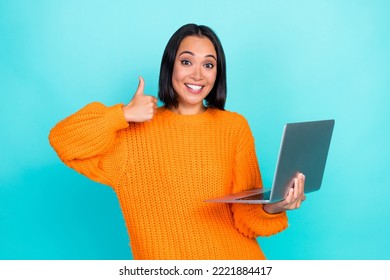 Photo of confident funny girl dressed orange pullover chatting modern gadget thumb up isolated teal color background - Shutterstock ID 2221884417