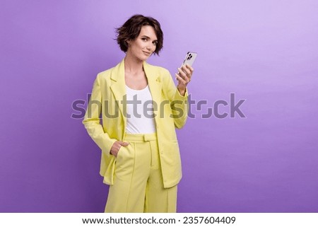 Photo of confident lady business analytics holding modern apple iphone 15 best gadget for influencers isolated on purple color background