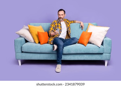 Photo of confident man boss wear plaid trendy clothes rest sit soft couch divan writing sms read news isolated on purple color background - Powered by Shutterstock