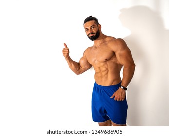 Photo of a confident man with a thumbs up gesture - Powered by Shutterstock