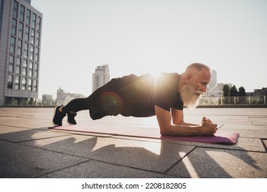 Photo of confident motivated old man stand elbow plank endurance stamina trainer wear t-shirt urban town outdoors - Shutterstock ID 2208182805