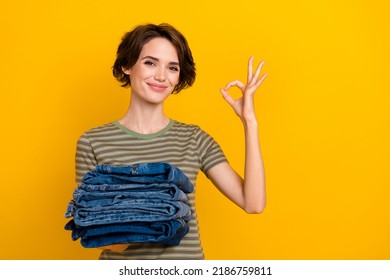 Photo of confident pretty lady wear striped t-shirt selling stuff showing okey empty space isolated yellow color background