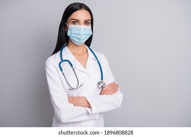 Photo Of Confident Serious Lady Doctor Wear White Coat Face Mask Arms Crossed Empty Space Isolated Grey Color Background