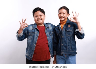 Photo of confident shiny schoolkids dressed white shirts showing two okey signs isolated white background - Powered by Shutterstock