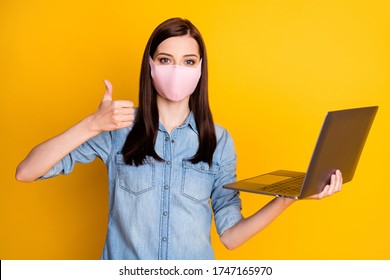 Photo Of Confident Student Beautiful Girl Work Remote Laptop Show Thumb Sign Approve Connection Technology Wear Denim Jeans Shirt Medical Mask Isolated Yellow Color Background