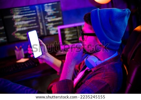 Photo of confident thoughtful guy dressed glasses hat typing twitter telegram facebook device empty space indoors workstation workshop home