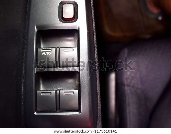Photo of a control\
switch of a car\'s windows