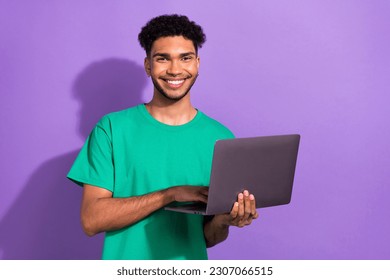 Photo of cool cheerful guy dressed green t-shirt chatting instagram twitter telegram facebook empty space isolated violet color background