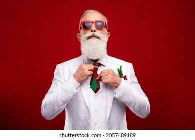 Photo Of Cool Confident Man Dressed White Christmas Costume Dark Glasses Preparing For Party Isolated Red Color Background