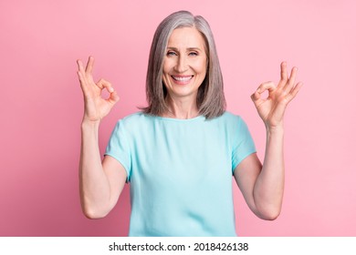 Photo of cool elder grey hairdo lady show okey sign wear teal blouse isolated on pink color background