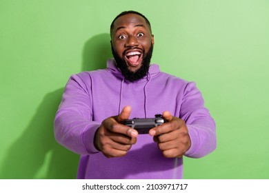 Photo of cool excited guy wear purple hoodie holding playstation ps open mouth isolated green color background