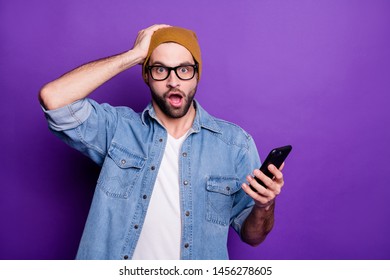 Photo Of Cool Guy Holding Telephone Reading Bad News Wearing Specs Casual Denim Outfit Isolated Violet Background